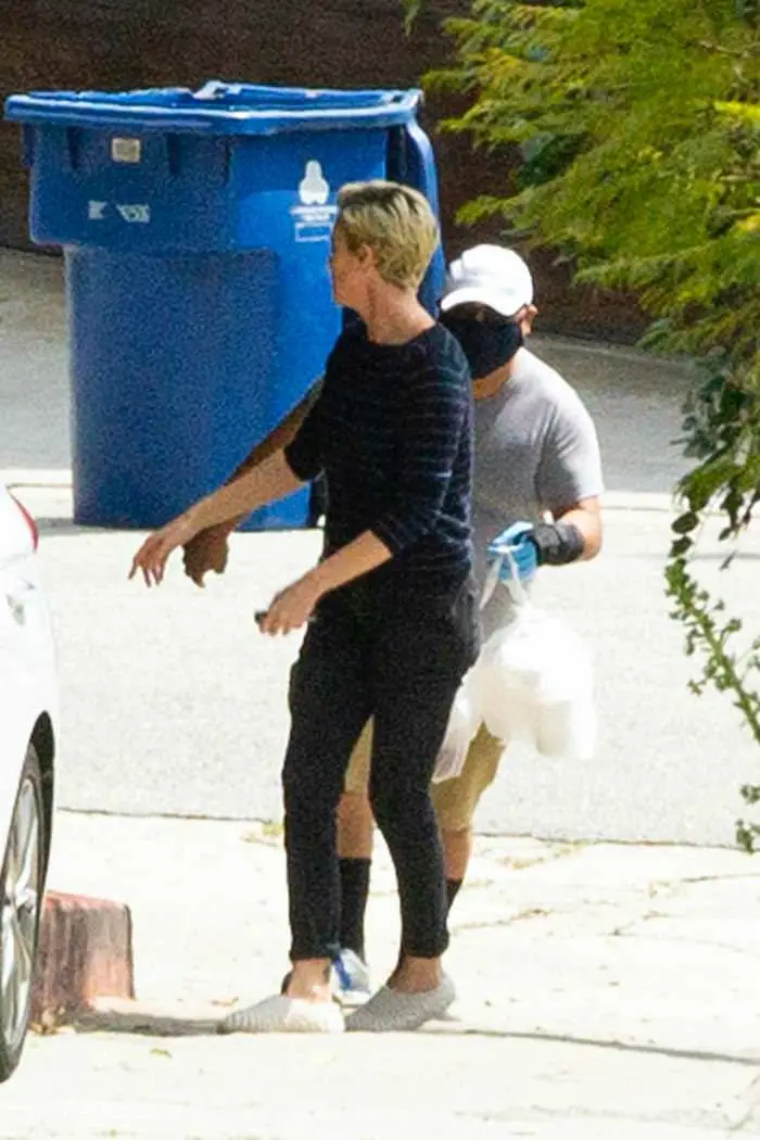 charlize theron outside her home grabbing a food delivery 1