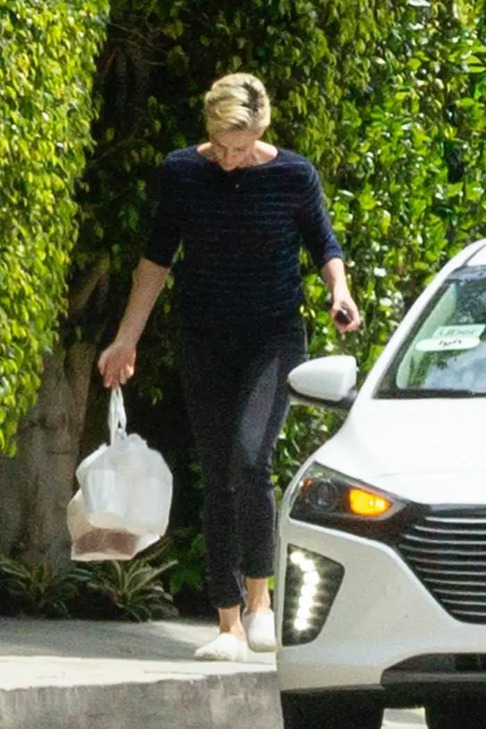 charlize theron outside her home grabbing a food delivery 3