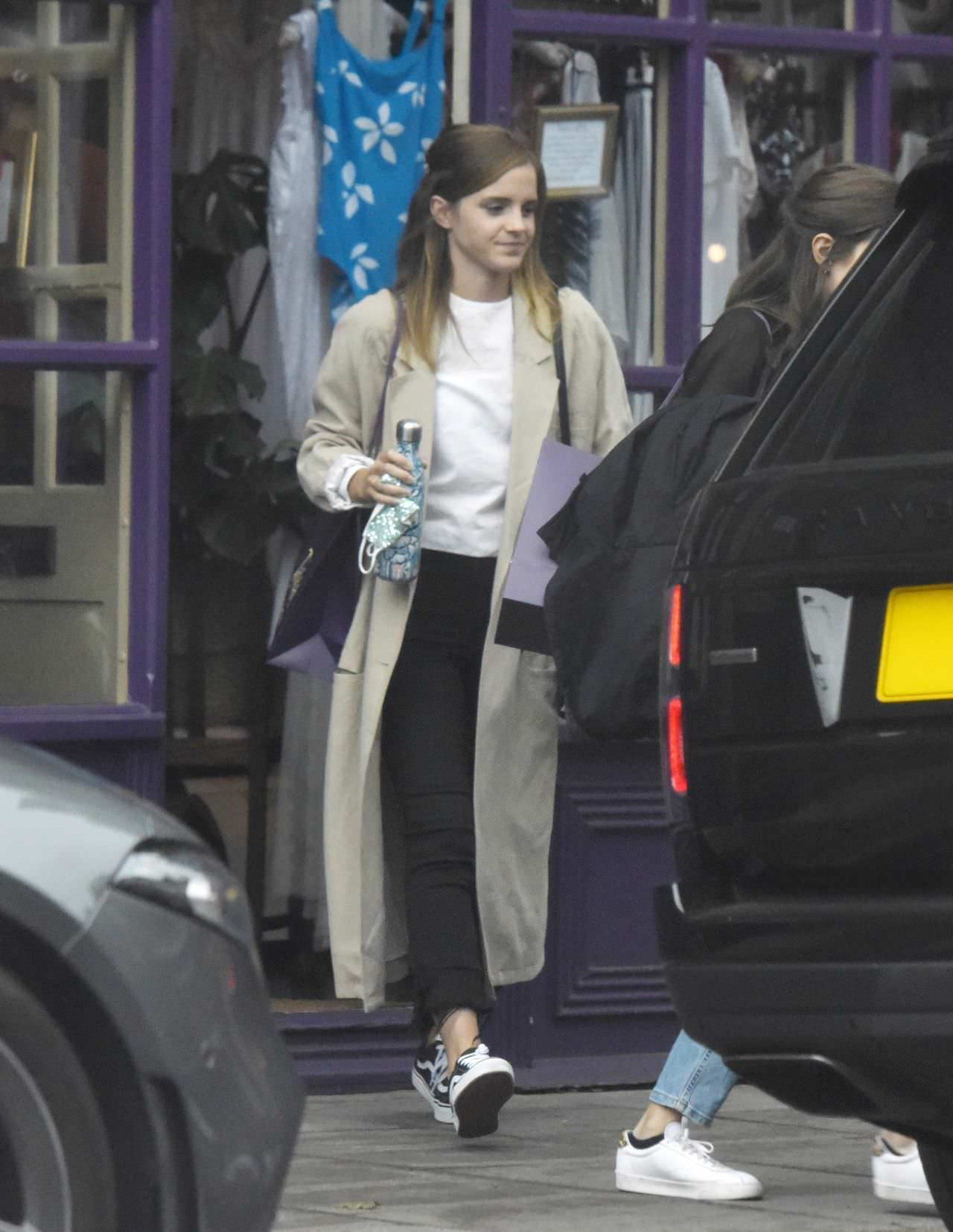 Emma Watson Fashions a Stylish Figure in a Stone Trench Coat