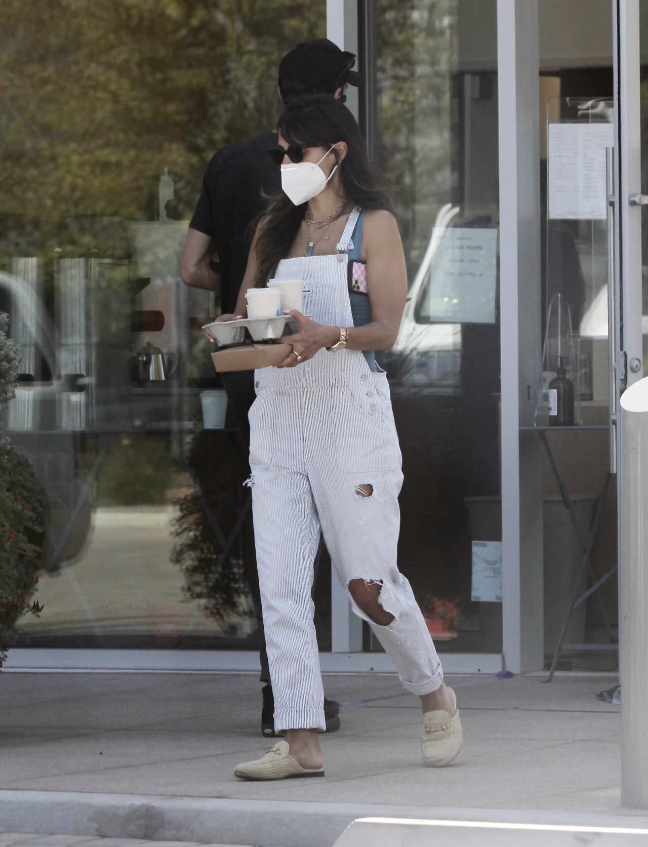 jordana brewster does a coffee run in distressed white overalls 3