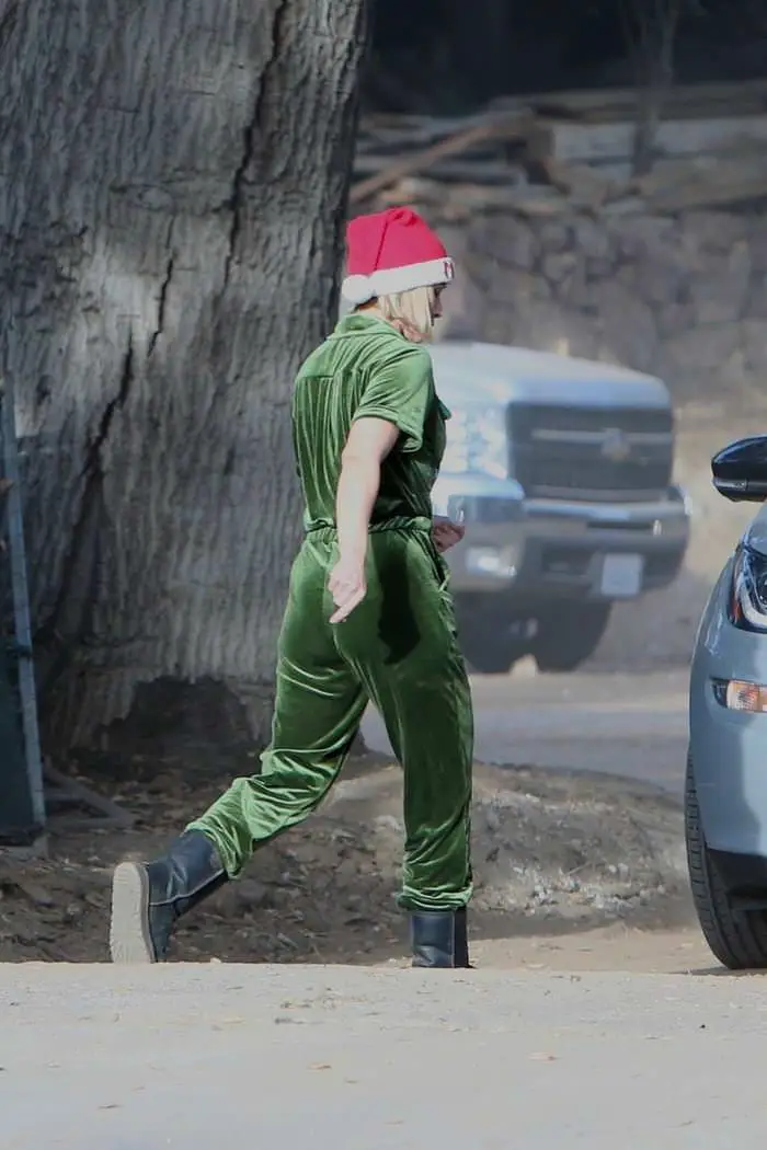 kristen bell dressed for the holidays in green overalls and a santa hat in la 2