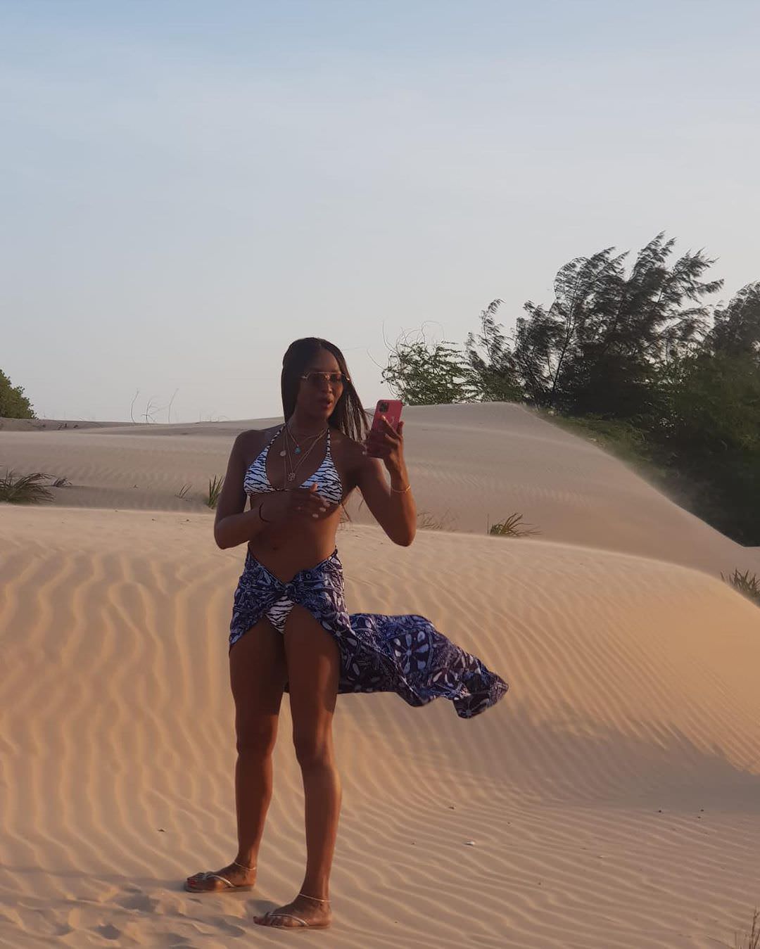 During her trip to Africa, the supermodel posed in the desert sand, dressed in Melissa Odabash's "Grenada" tiger-print bikini with a blue sarong.