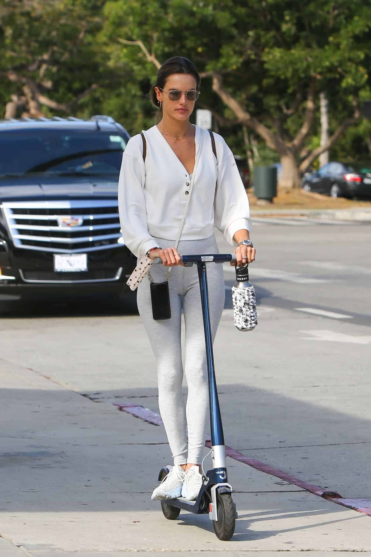 Alessandra Ambrosio Goes Scooter Ride in a Baggy Sweater and Blue Leggings