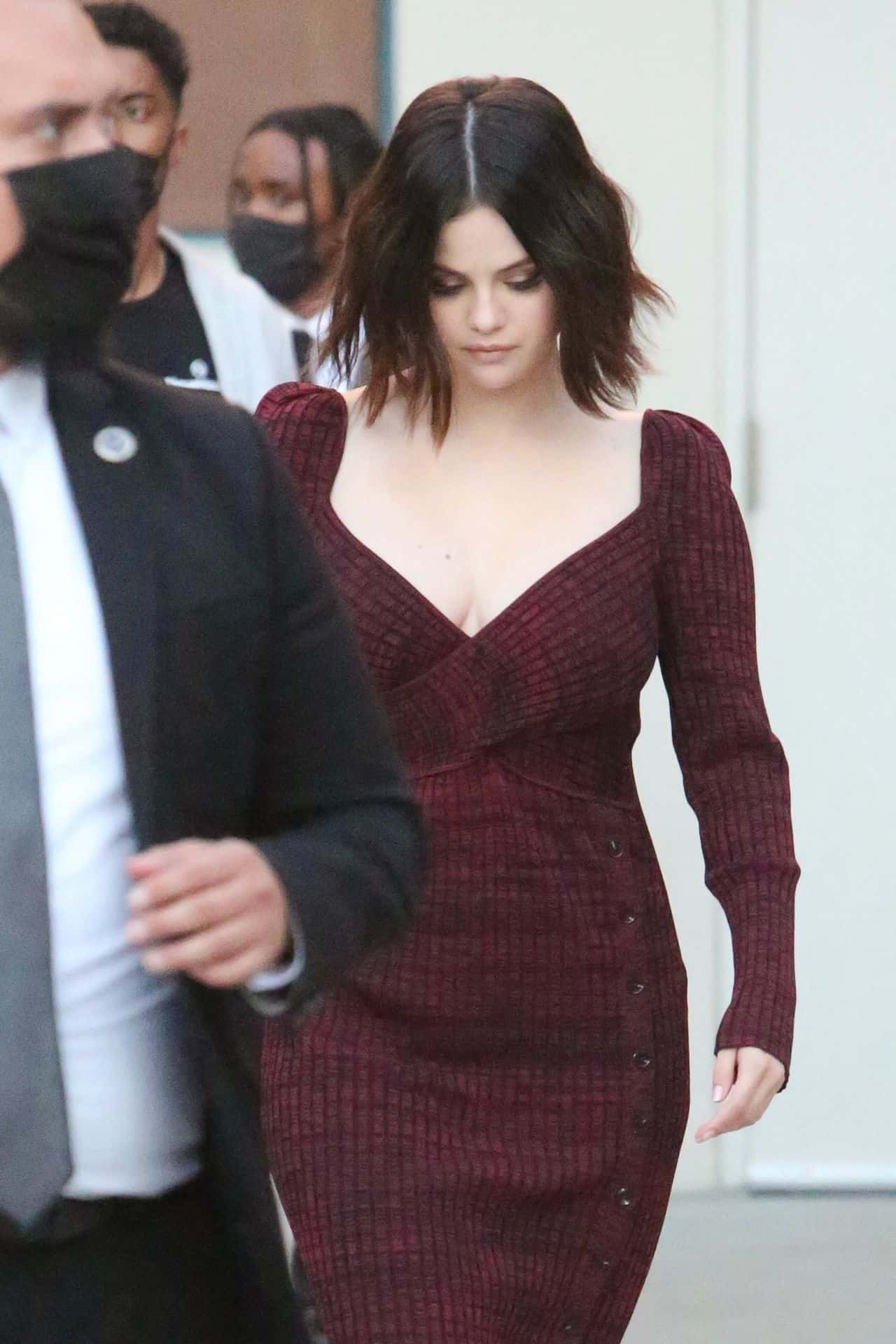 Selena Gomez Signs Autographs and Poses in a Beautiful Burgundy Dress in LA
