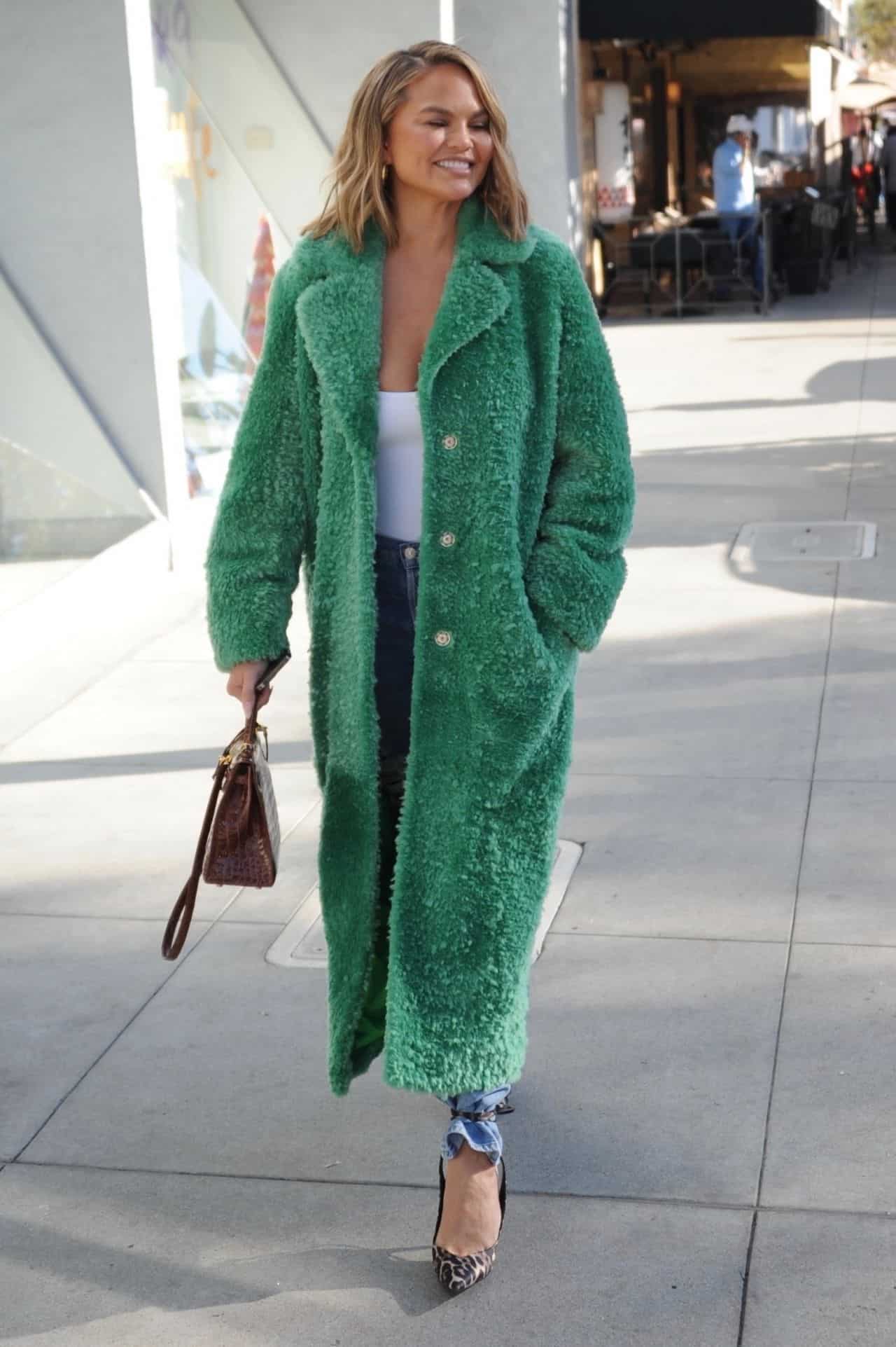 Chrissy Teigen Arrives in Style Wearing a Long Green Coat at Il Pastaio