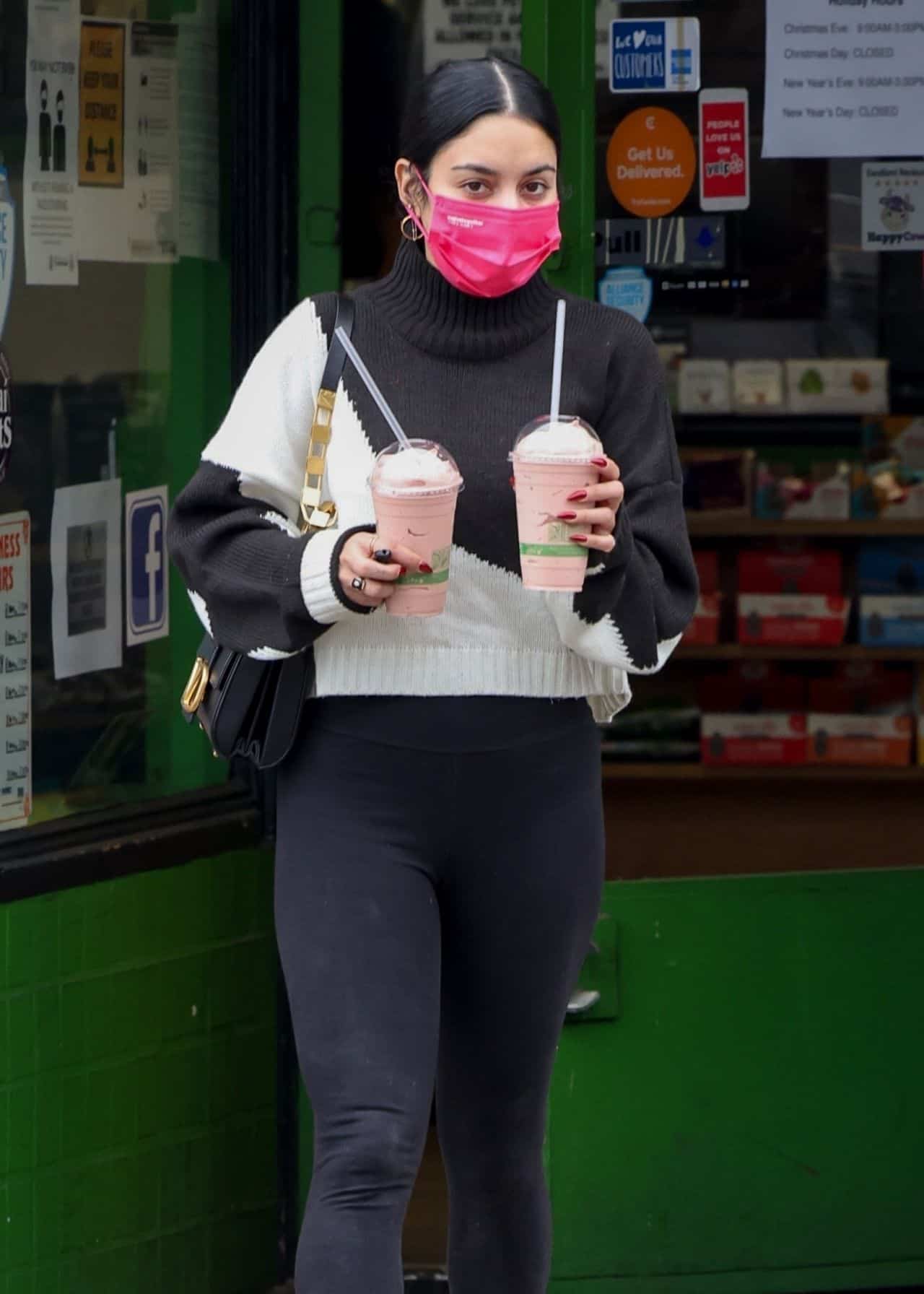 vanessa hudgens looked chic in black and white while carrying two smoothies 09