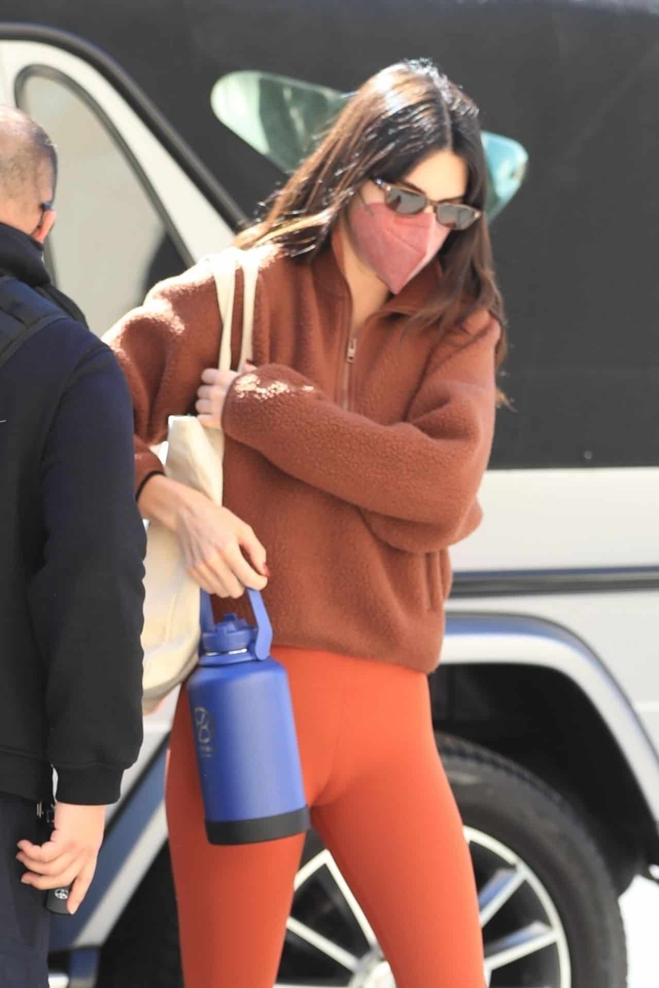 Kendall Jenner Flashes her Taut Midriff in Orange Athletic Wear in WeHo
