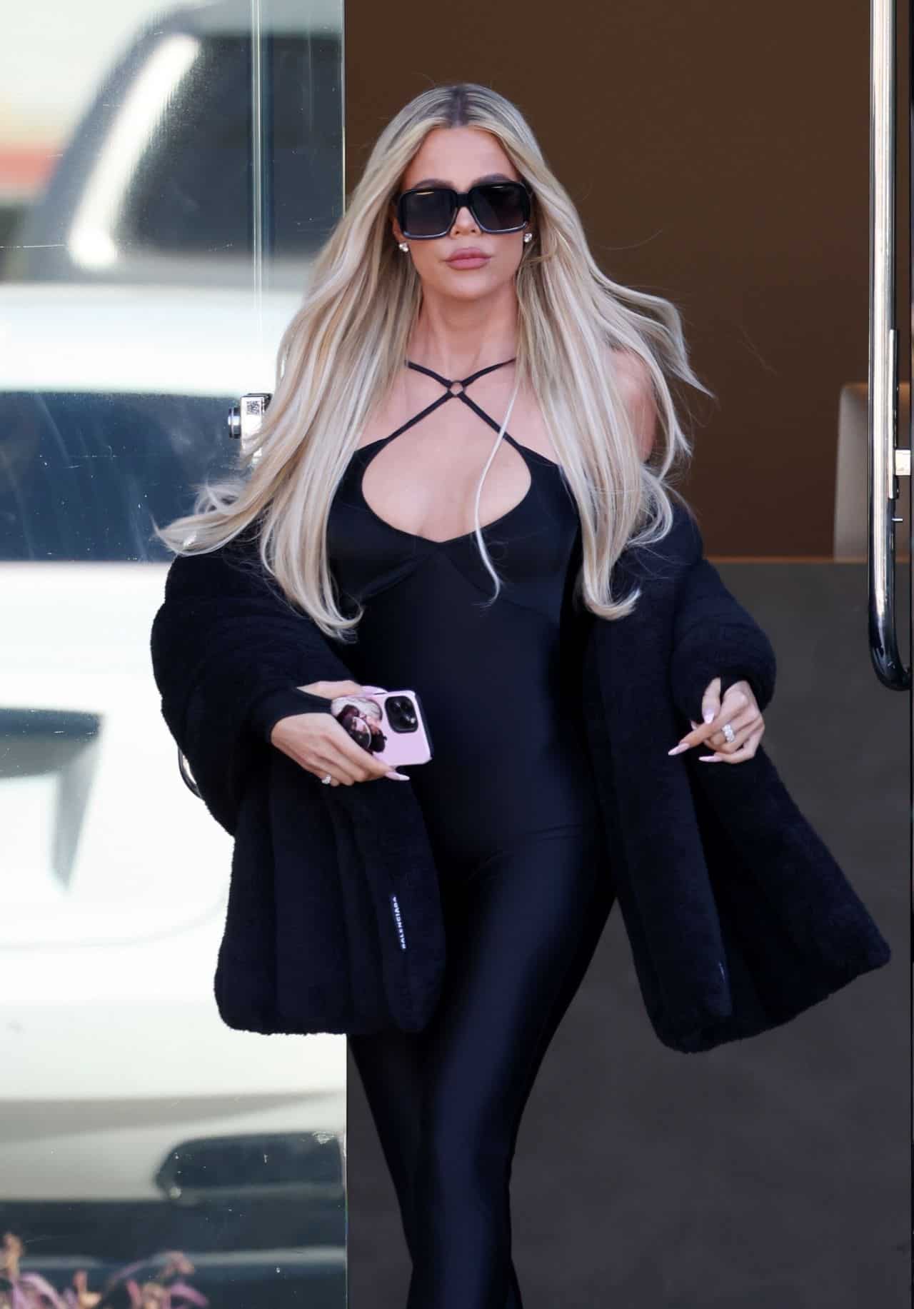 Khloe Kardashian Shows Off her Slim Figure in a Black Catsuit and Fur Coat