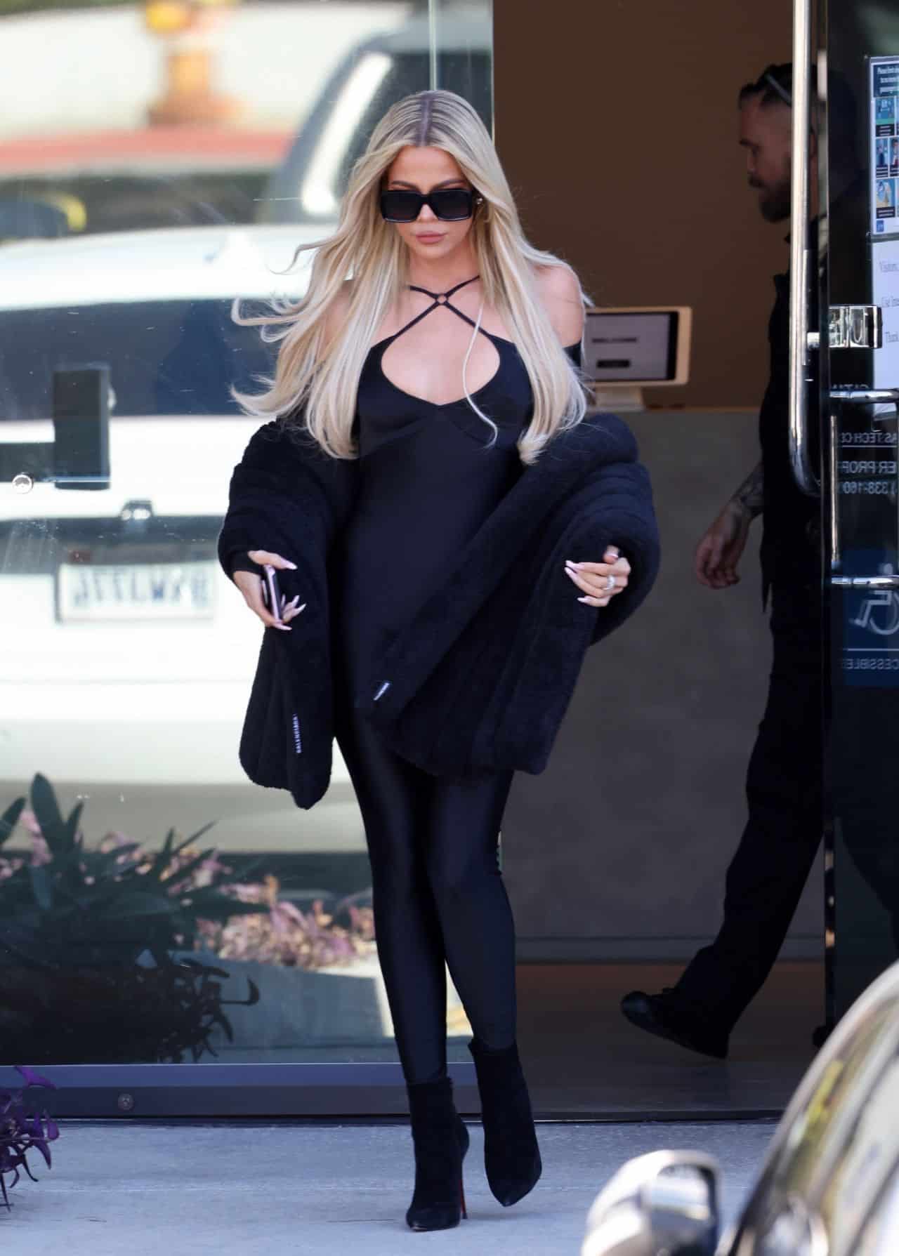 Khloe Kardashian Shows Off her Slim Figure in a Black Catsuit and Fur Coat