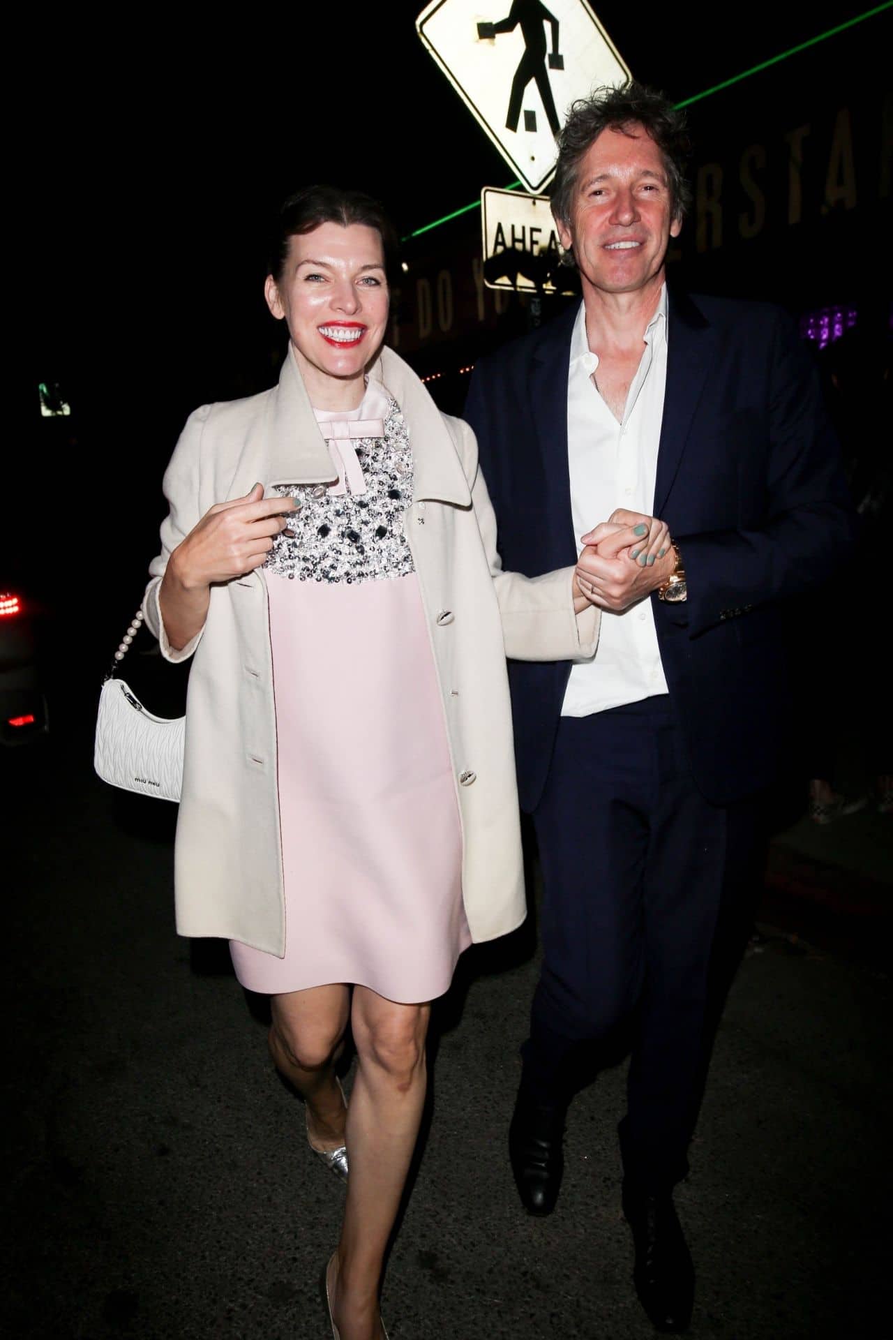 Milla Jovovich Stuns with her Glowing Smile and Pink Dress at Prada Event