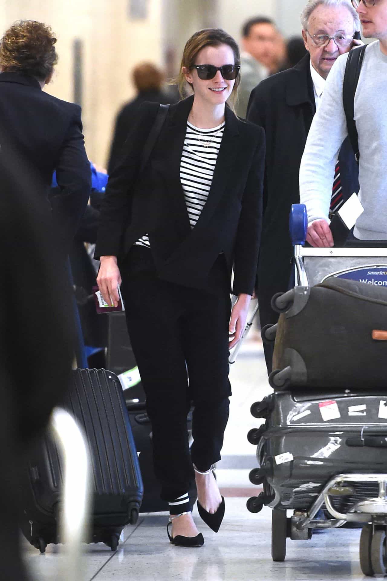 Emma Watson Arrives with Style at JFK Airport in a Striped Top and Blazer