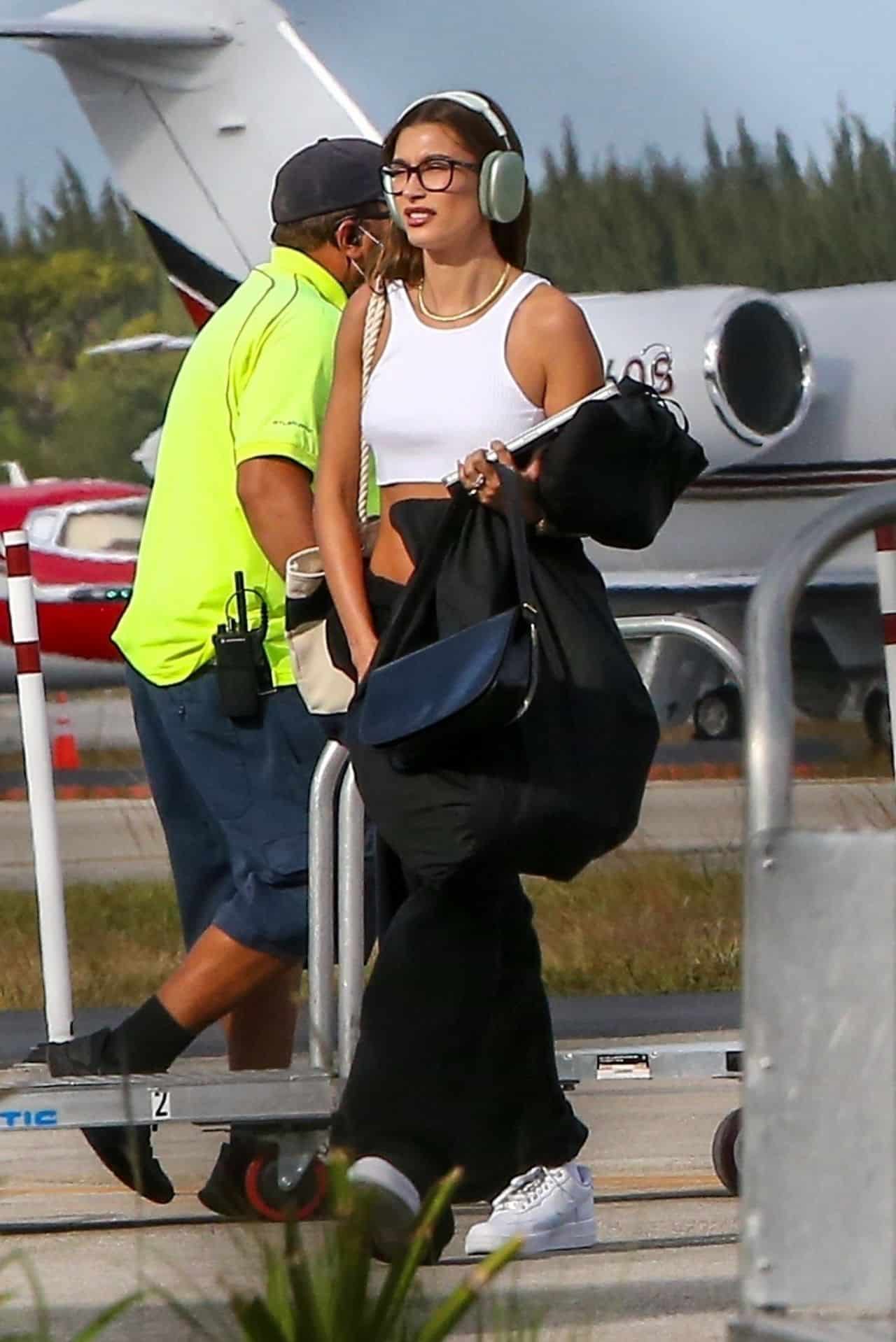 Hailey Bieber in a Crop Top and Sweats Steps Off a Private Plane in Miami