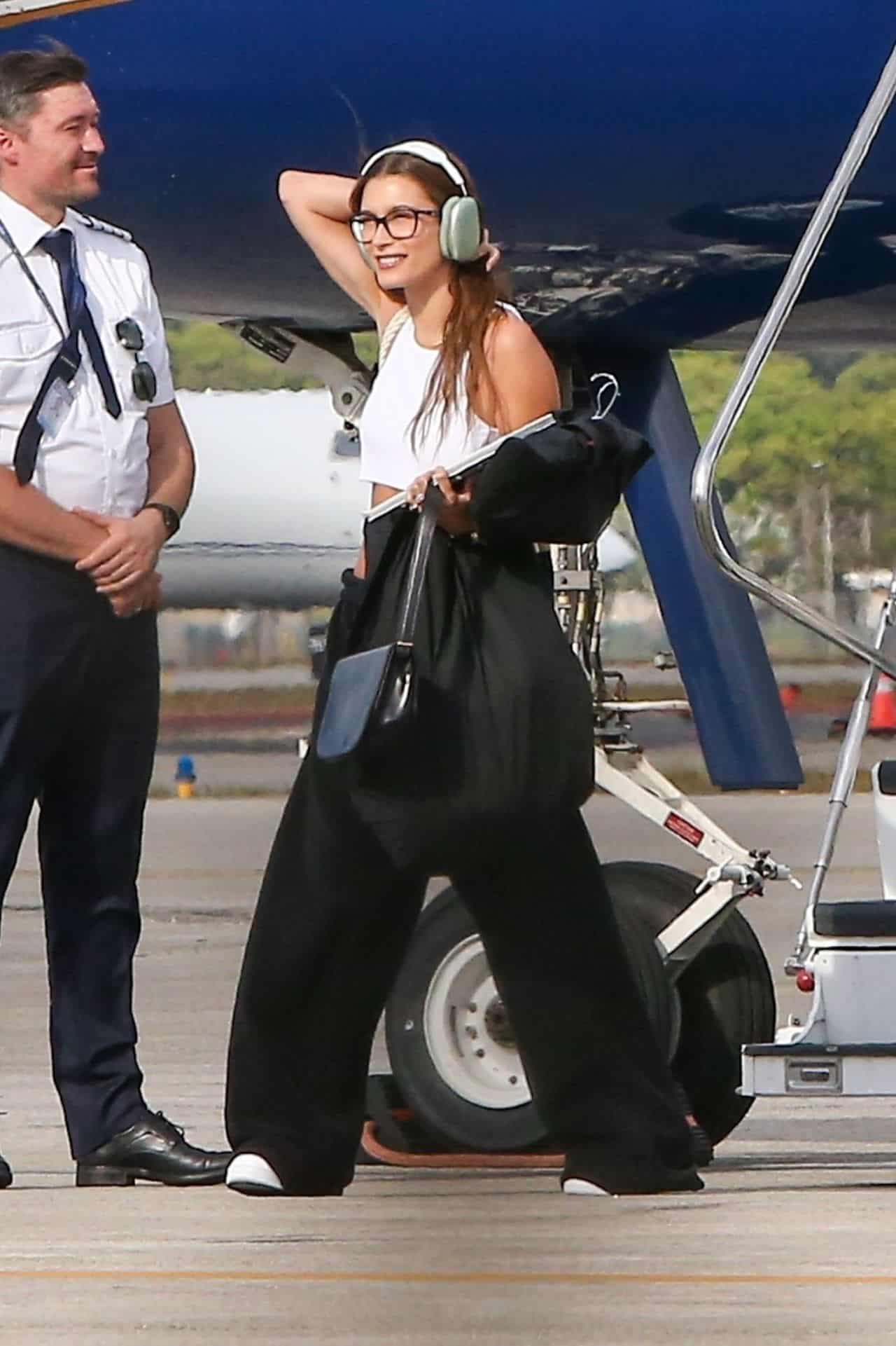 Hailey Bieber in a Crop Top and Sweats Steps Off a Private Plane in Miami