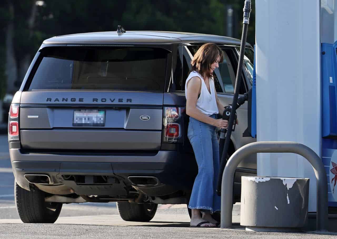 Milla Jovovich Stops at a Gas Station to Fill Up her Tank and Grab a Coffee
