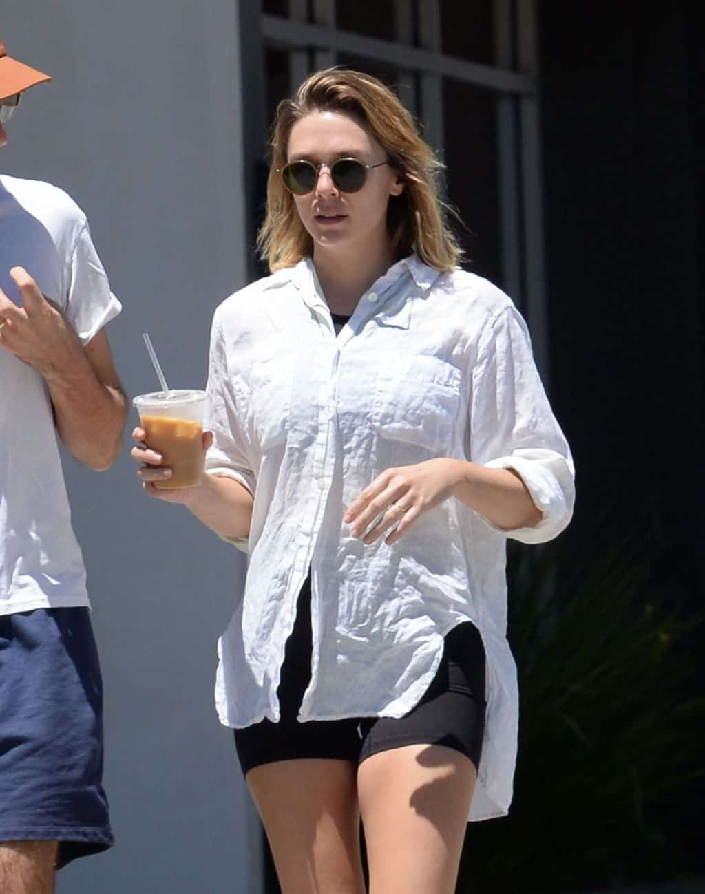 Elizabeth Olsen Wears Black Yoga Shorts During a Casual Walk with Husband