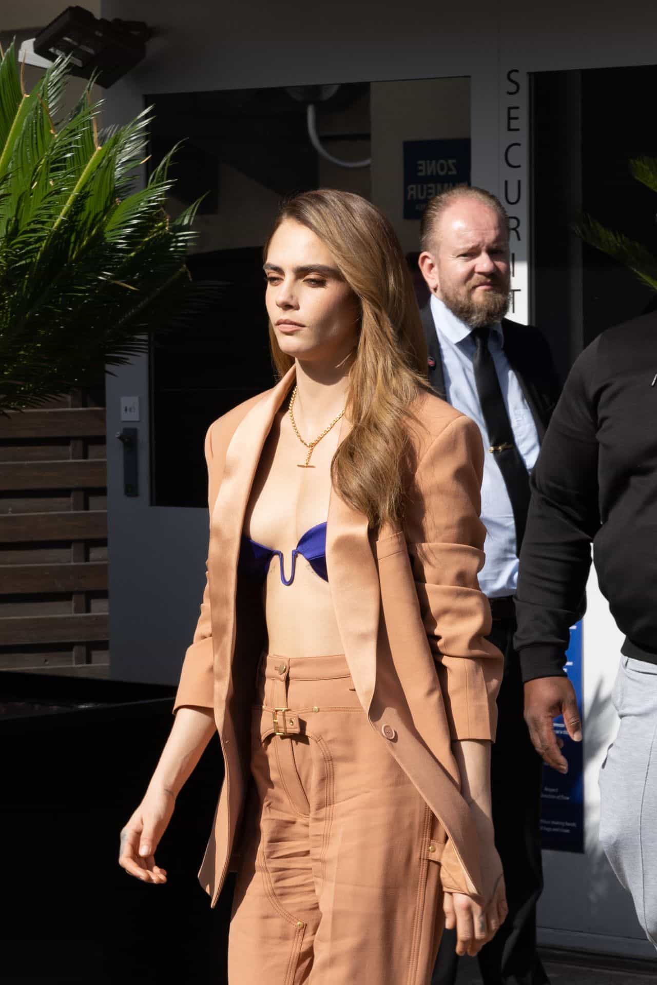Cara Delevingne Flashes her Satin Bra Top while Leaving her Hotel in Cannes, France