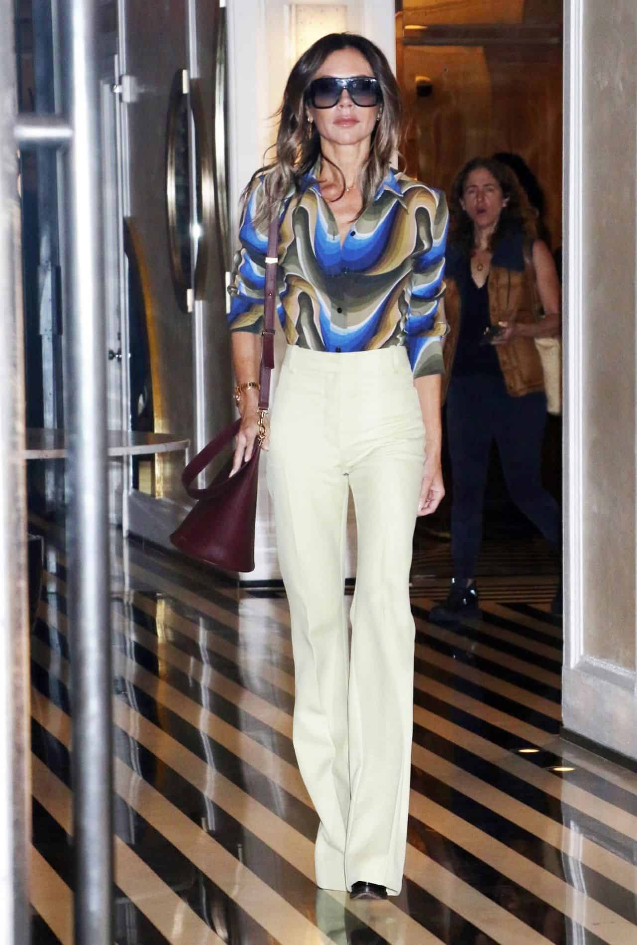 Victoria Beckham Oozes 70s Chic in a Colorful Shirt and Cream Pants in NY
