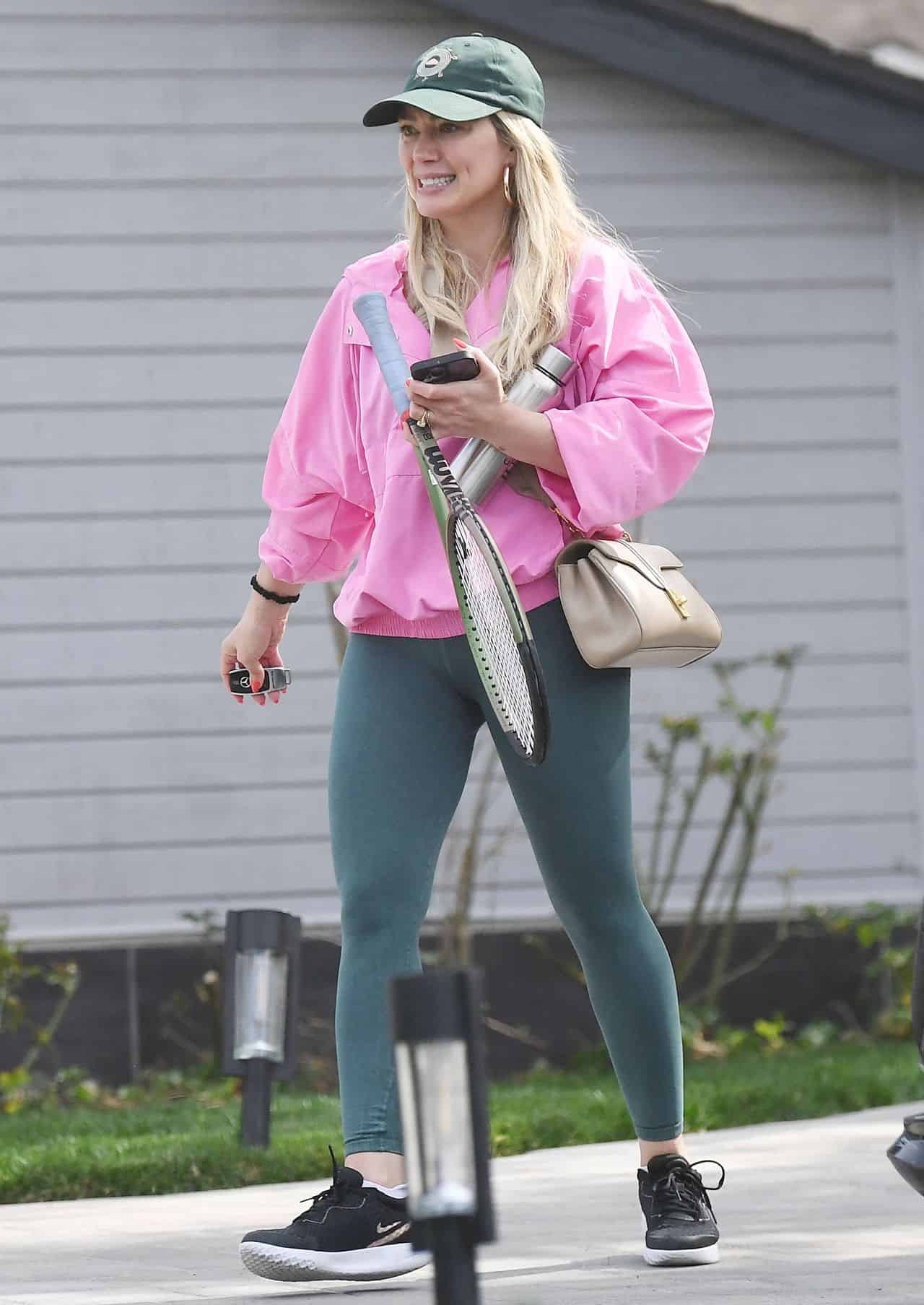 Hilary Duff in Sports Jumpsuit and Pink Windbreaker for Tennis Game