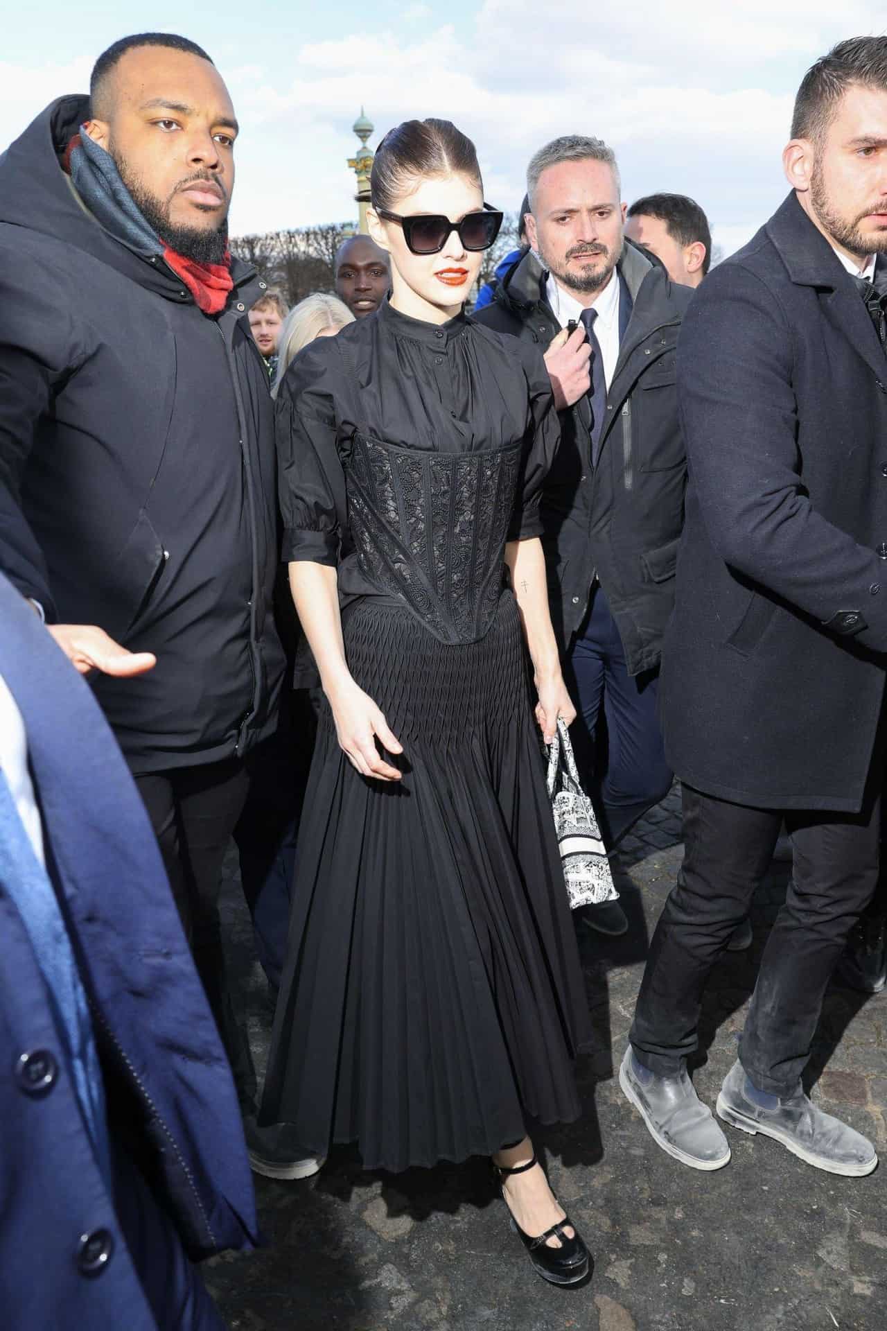 Alexandra Daddario in Gothic Dress Attends Dior's Fall 2023 Show at PFW