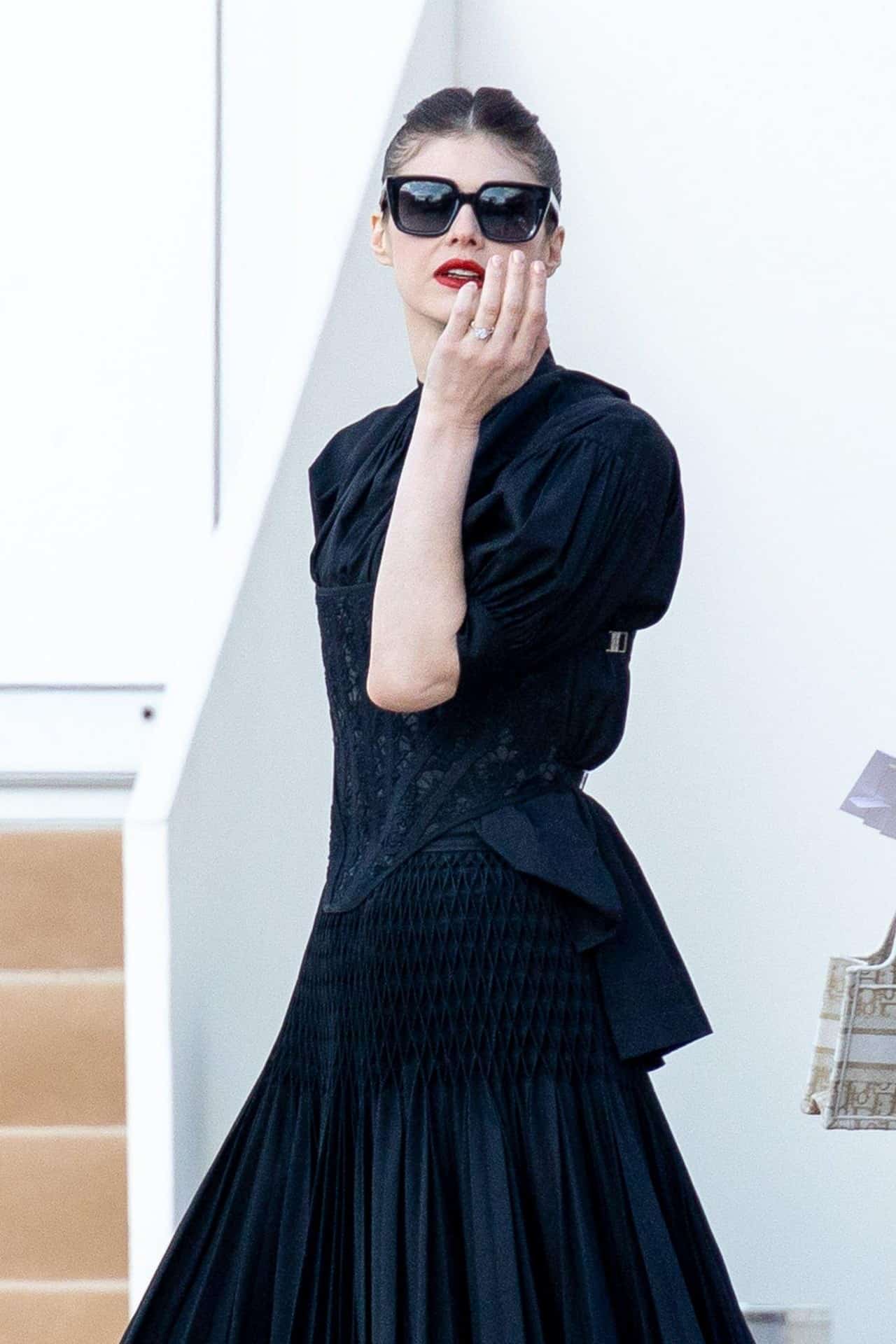 Alexandra Daddario in Gothic Dress Attends Dior's Fall 2023 Show at PFW