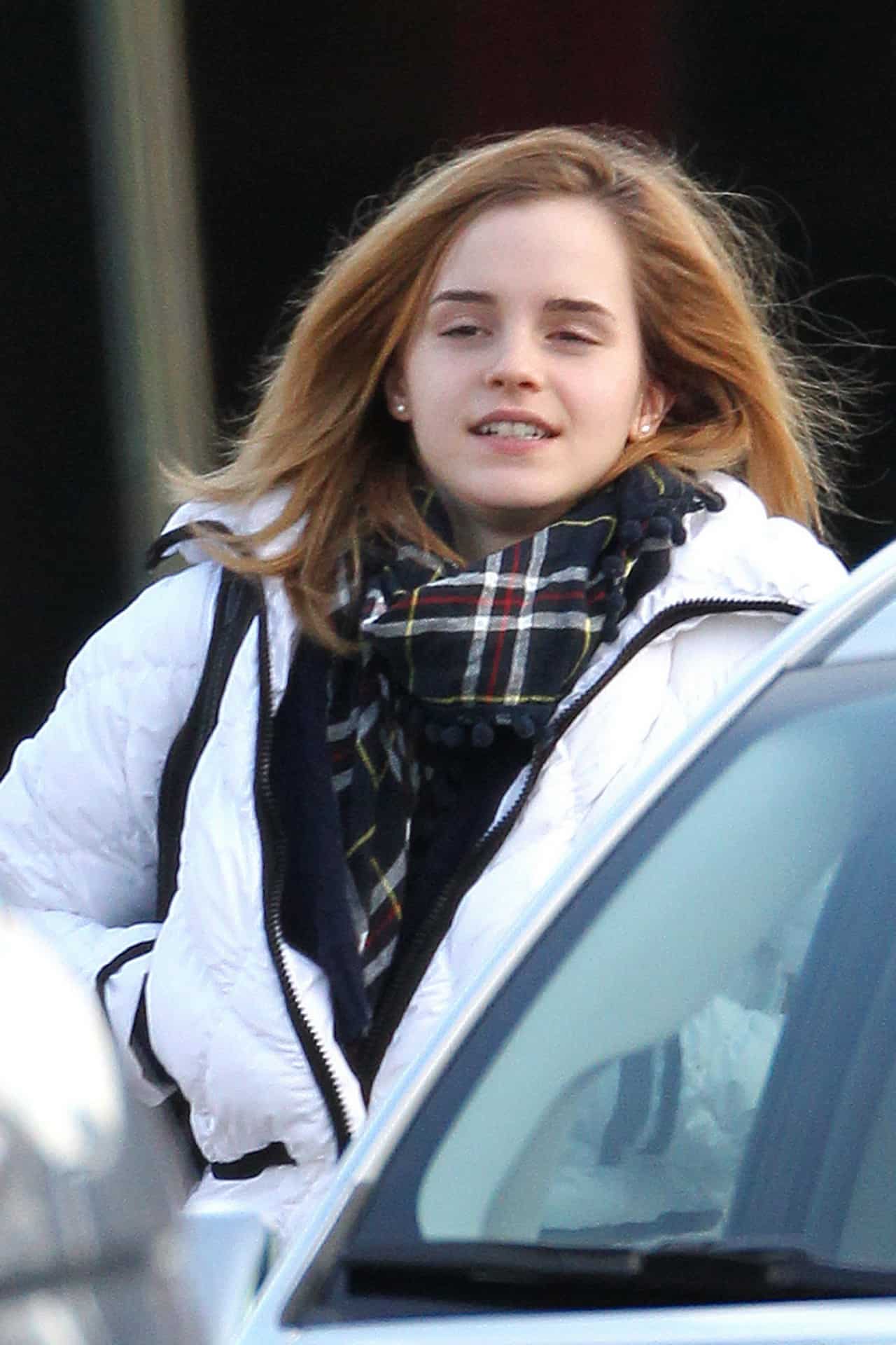 Emma Watson Styles a White Puffer Jacket with Tight Jeans and Fringe Boots