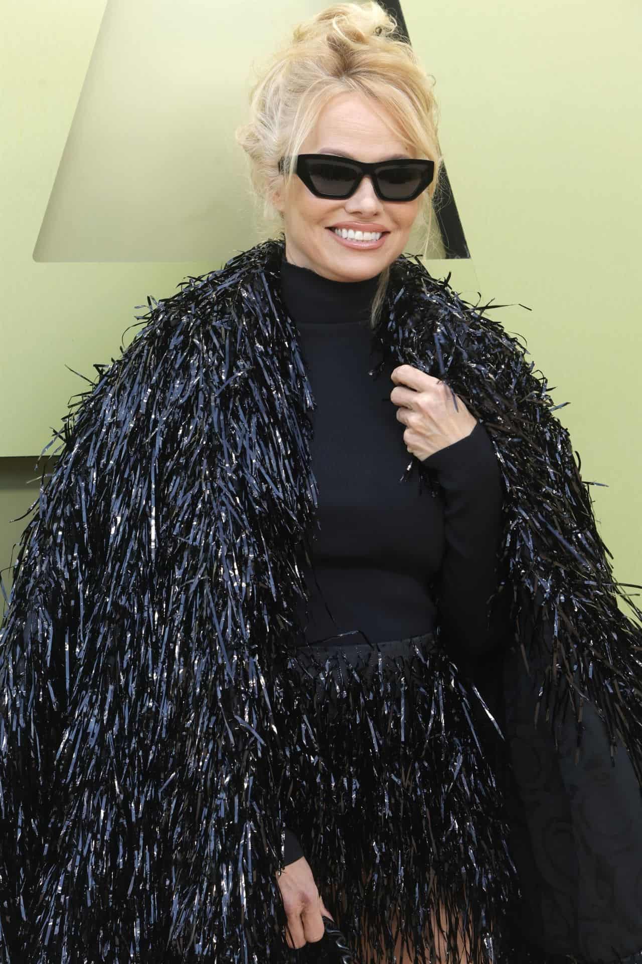 Pamela Anderson Stuns in a Black Fringe Coat at Versace’s Fall 2023 Show