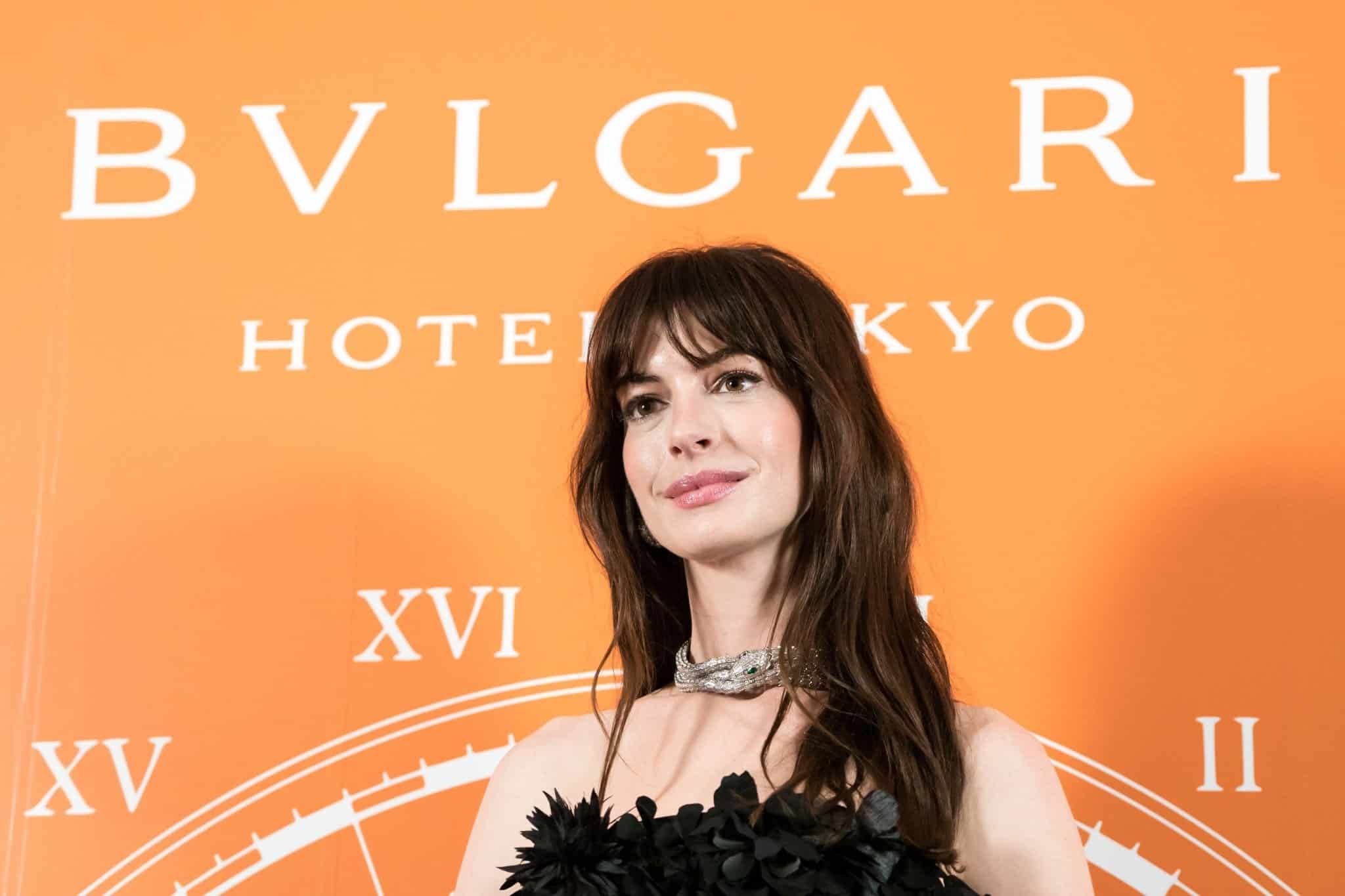 Anne Hathaway Attends Bvlgari Photoshoot in Black Mini Dress in Tokyo