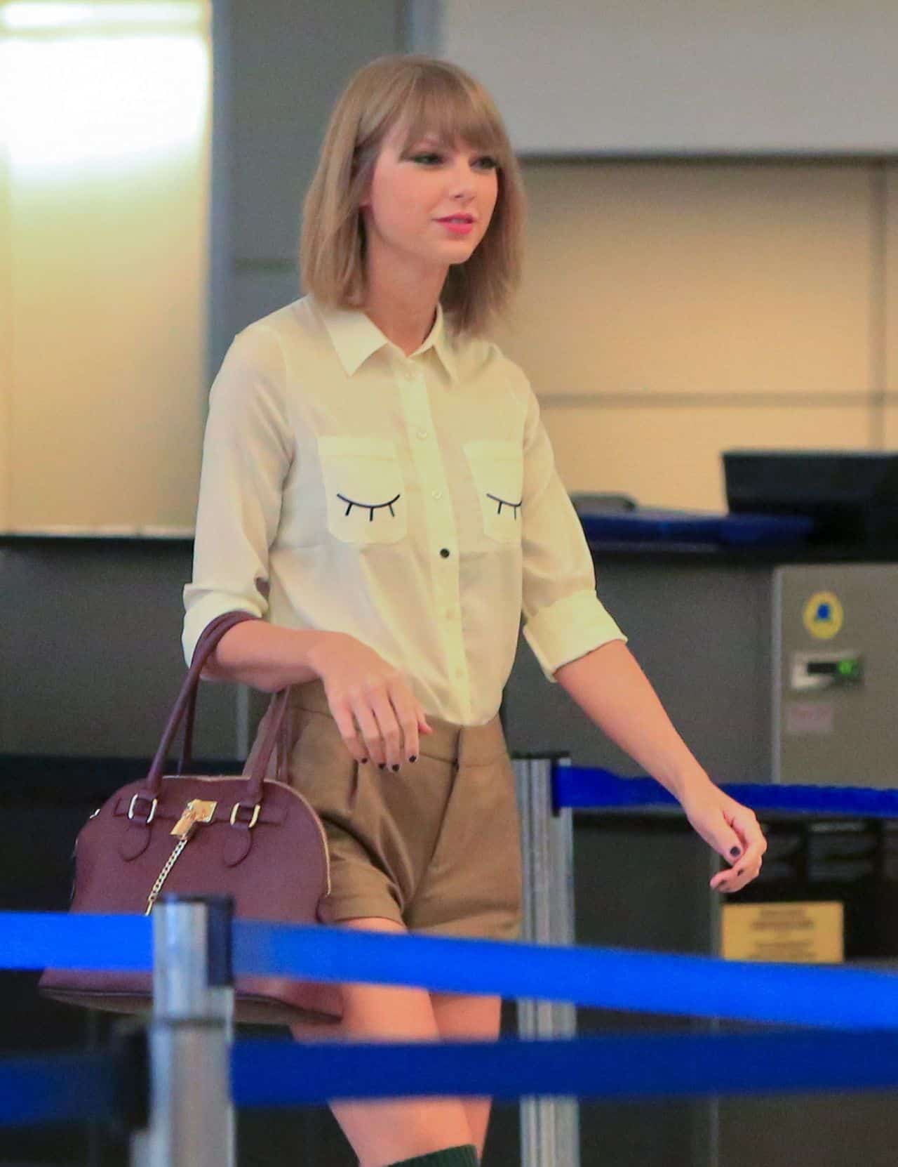 Taylor Swift Wears Brown Shorts and a White Shirt at LAX Airport