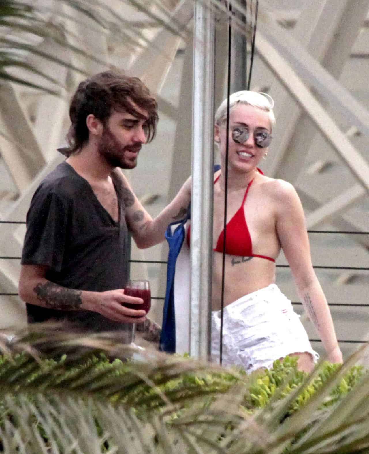 Miley Cyrus in Red Bikini Having Fun Poolside with Friends in Barcelona
