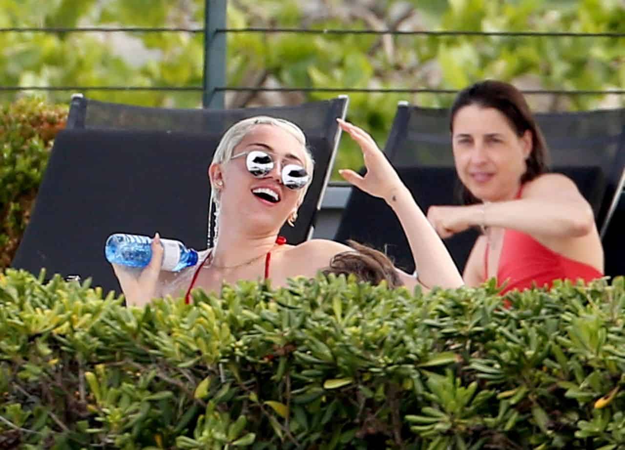 Miley Cyrus in Red Bikini Having Fun Poolside with Friends in Barcelona