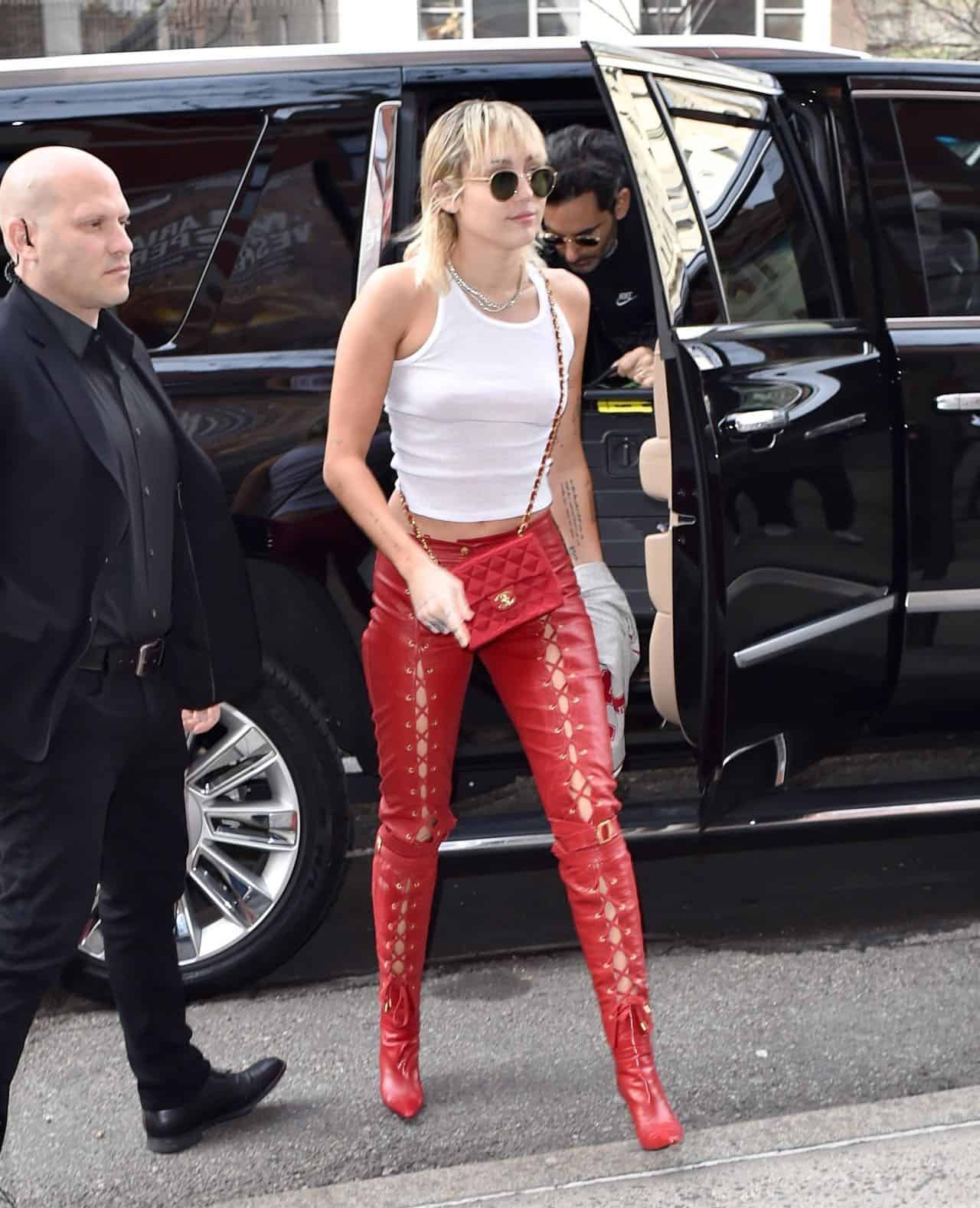 Miley Cyrus Stuns in Fiery Red Leather Lace-Up Pants and Coordinated Boots