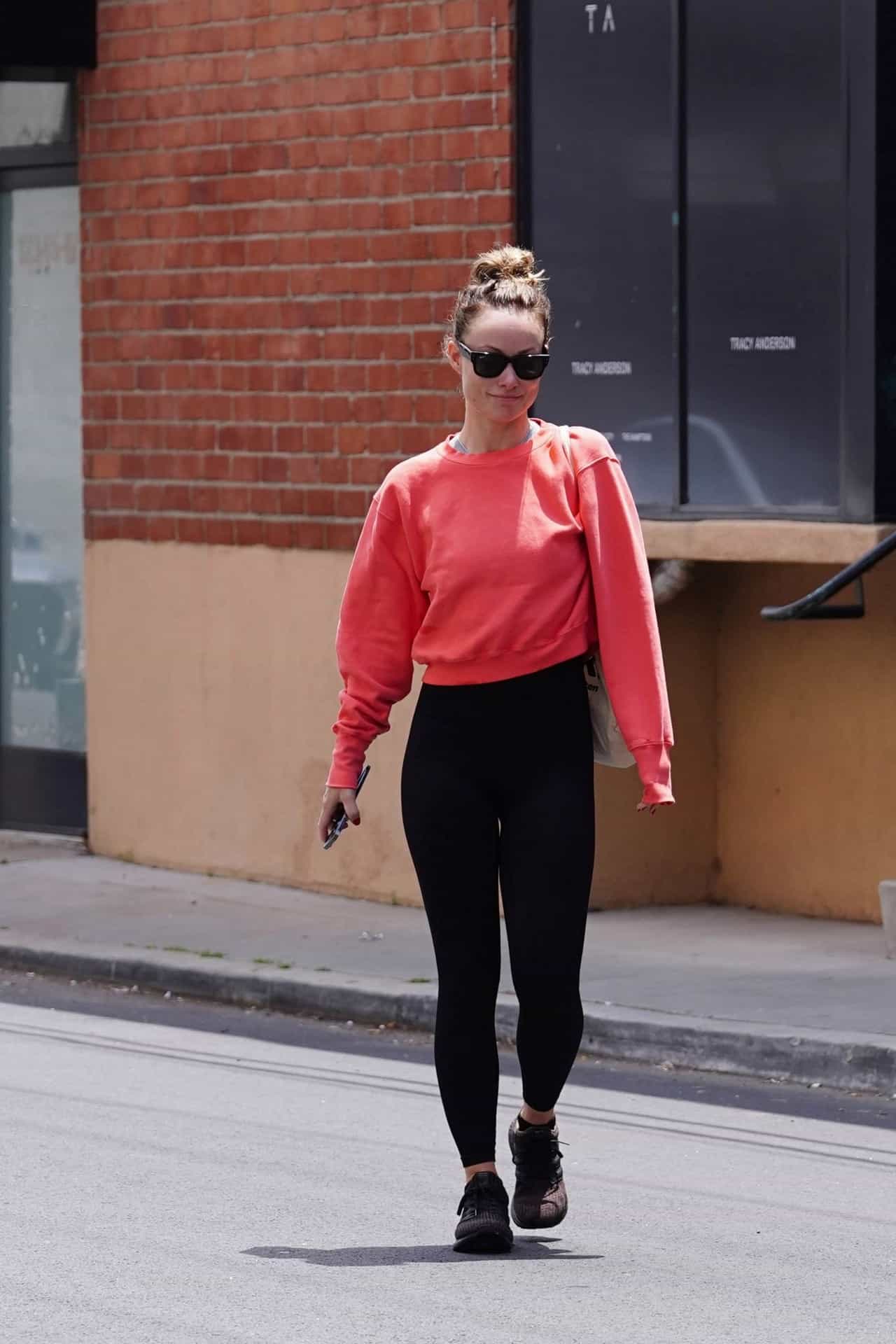 Olivia Wilde Leaves the Gym in Hot Pink Crew-Neck Sweater and Black Leggins