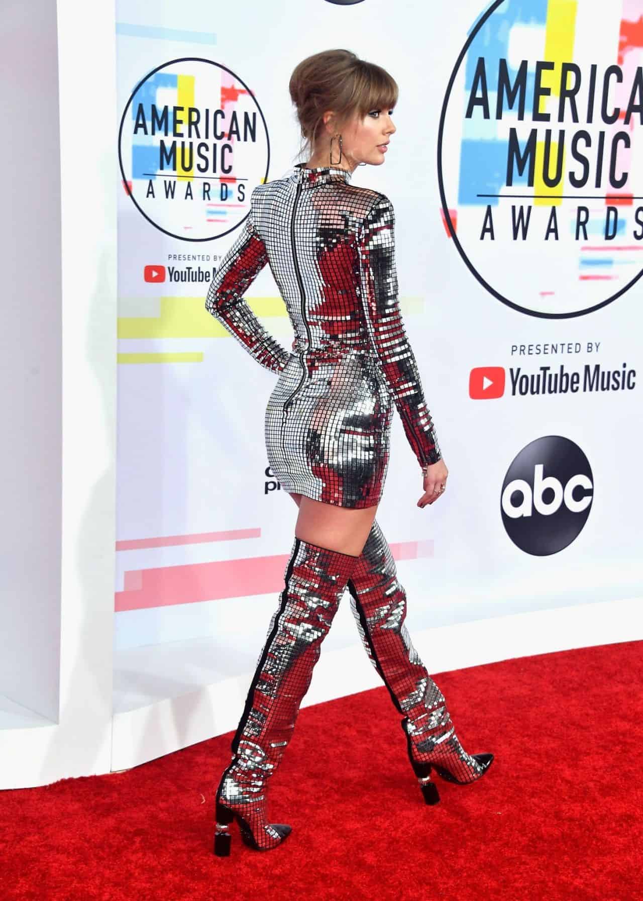 Taylor Swift Shines in Silver Mini Dress and Thigh-High Boots at AMAs