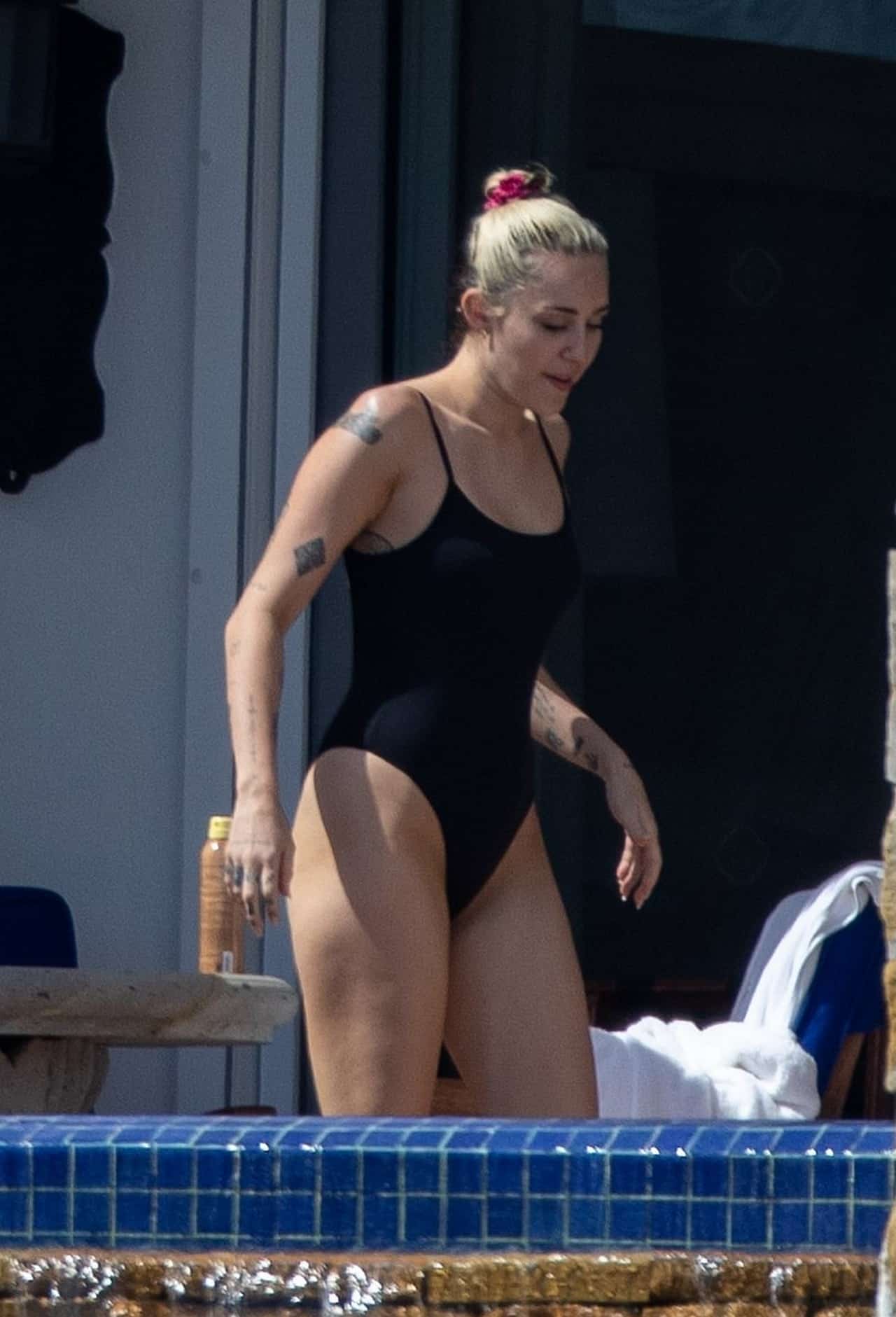 Miley Cyrus Shows Off Toned Legs in Black One-Piece in Cabo San Lucas