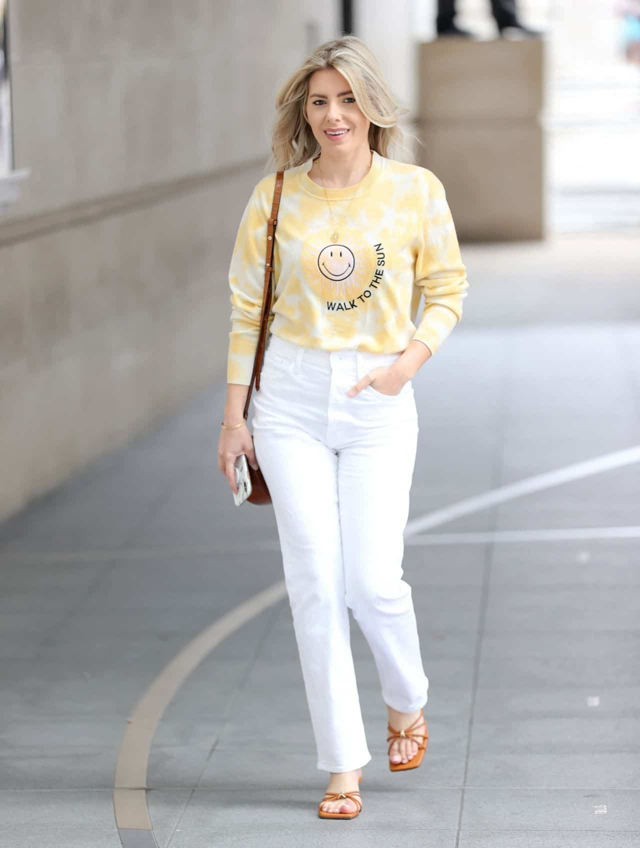 mollie king wears yellow sweater and white jeans on her way to bbc radio 1 4