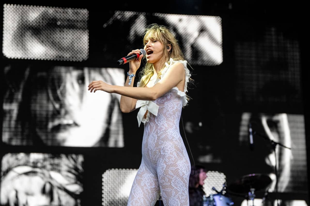 Suki Waterhouse Sizzles in Plunging Lace Jumpsuit at Lollapalooza