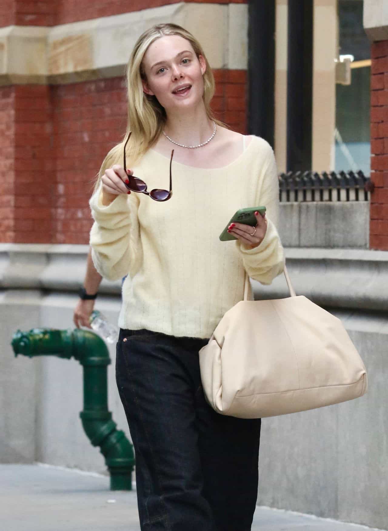 Elle Fanning Rocks Buttery Yellow Top and Black Pants in New York City