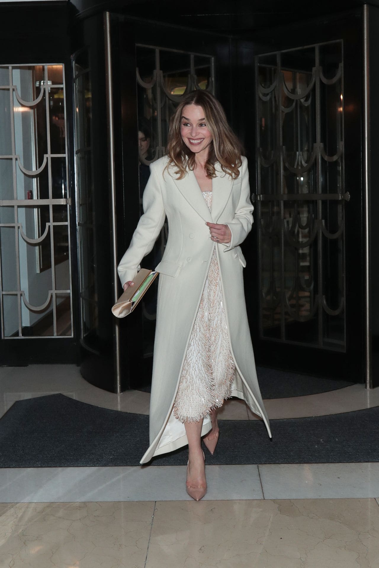 Emilia Clarke Radiates Elegance in Flowing Coat and Dazzling Dress