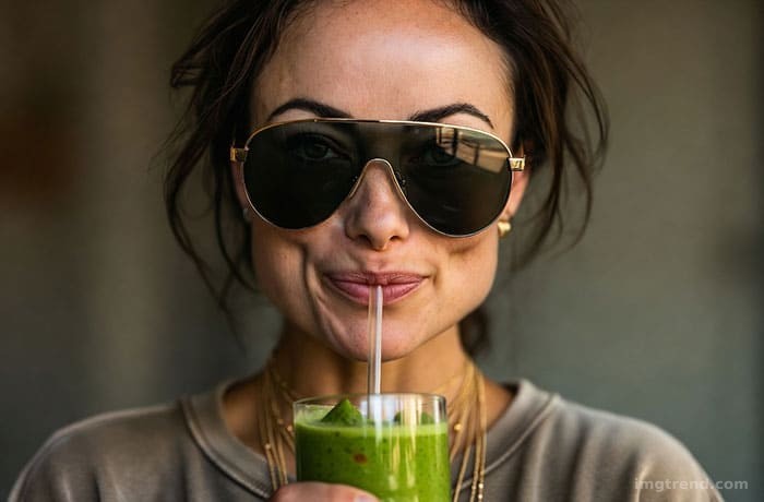 Illustration of Olivia Wilde holding a green smoothie, wearing oversized sunglasses and a messy ponytail